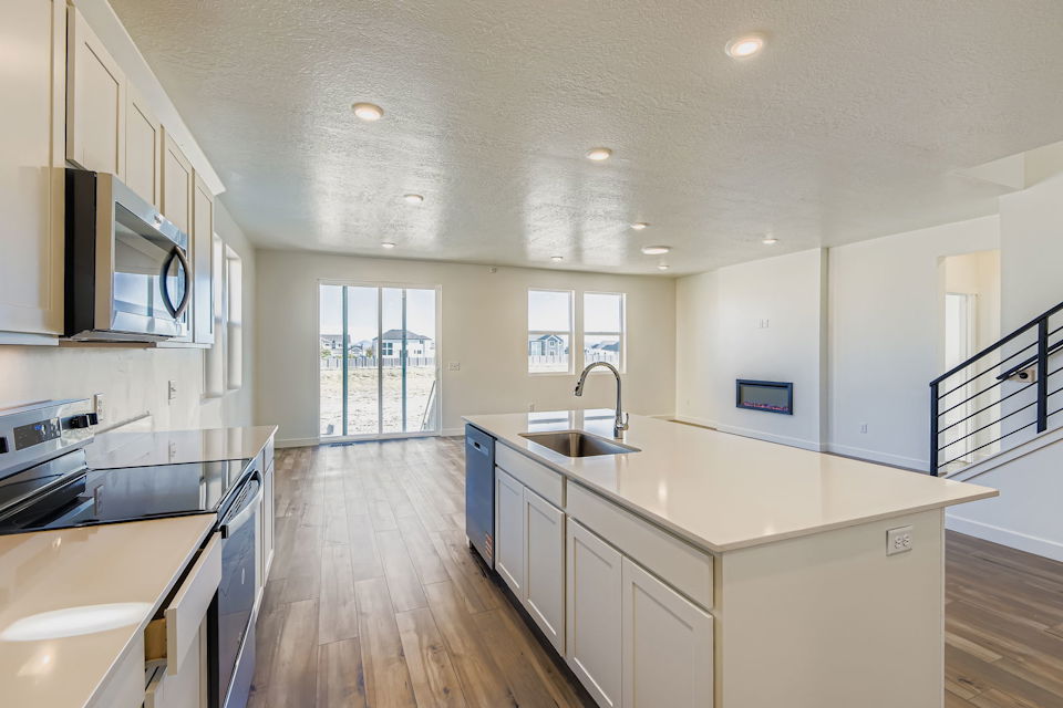 A kitchen with white cabinets.
