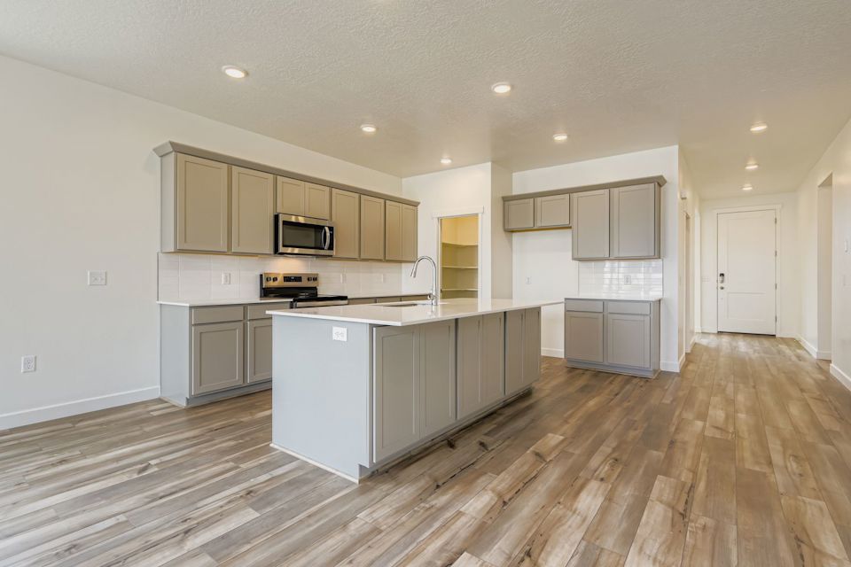 A kitchen with white cabinets.