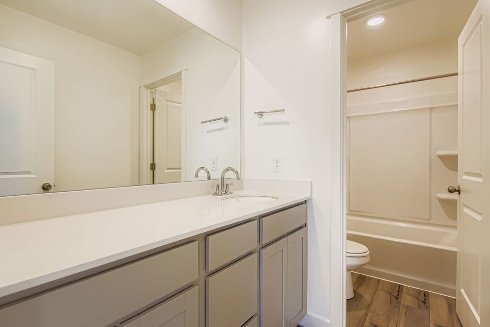 A bathroom with a tub toilet and sink.