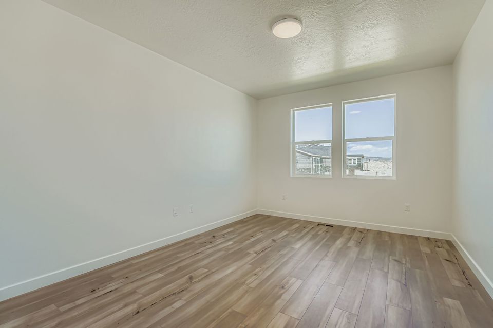 A room with a wood floor and a window.