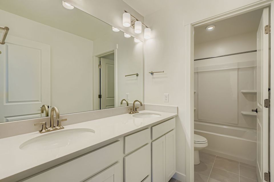 A bathroom with a sink toilet and shower.