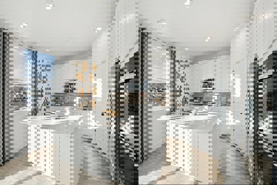 A kitchen with white cabinets.