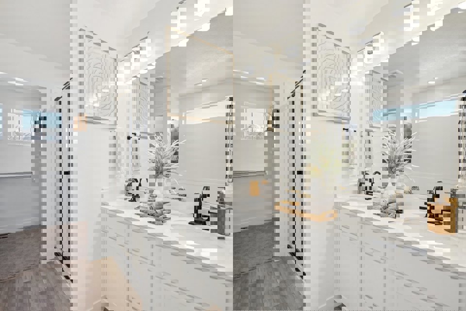 A bathroom with white cabinets.