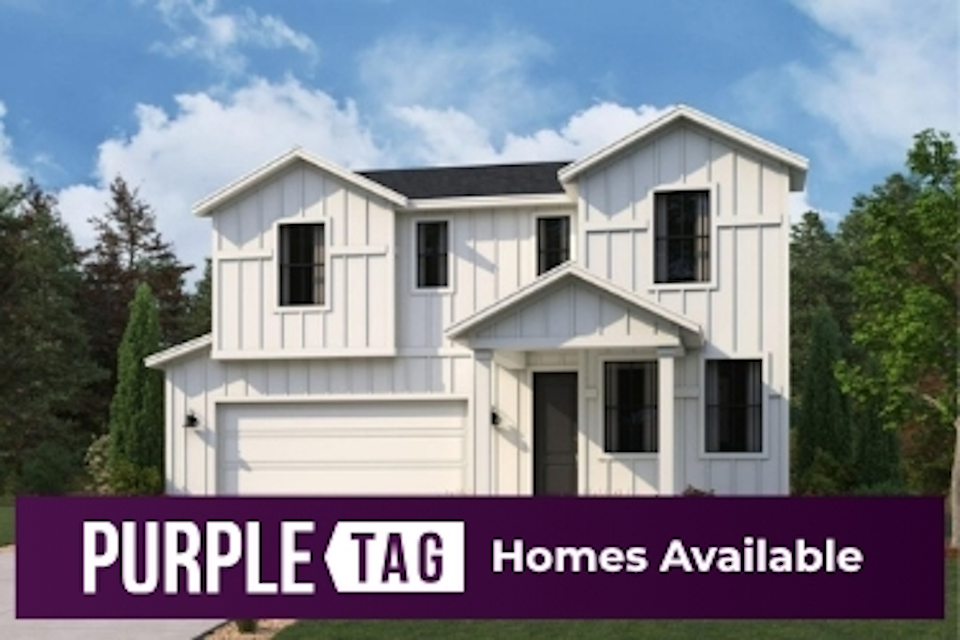 A white house with trees in the back.