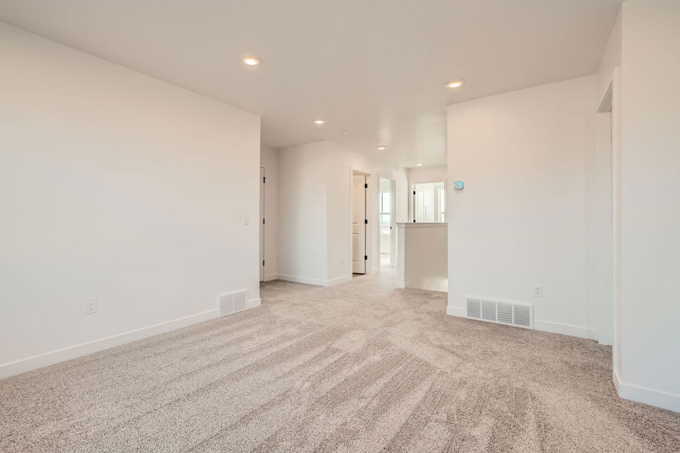 A long hallway with white walls.