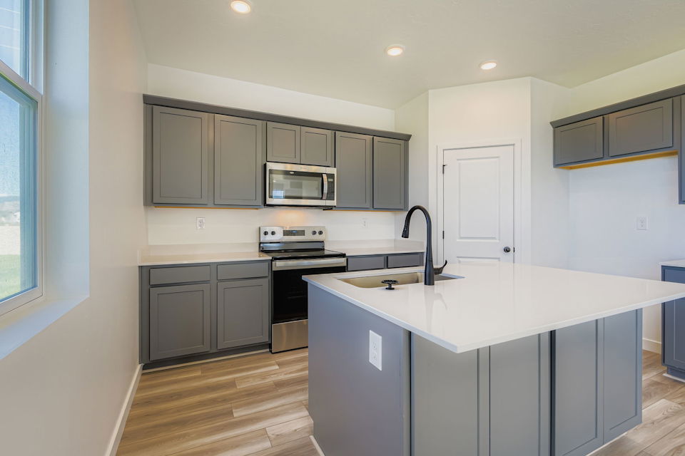 A kitchen with white cabinets.