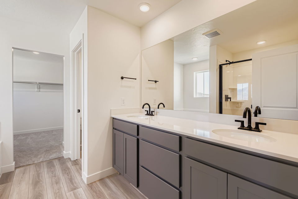 A bathroom with a large mirror.