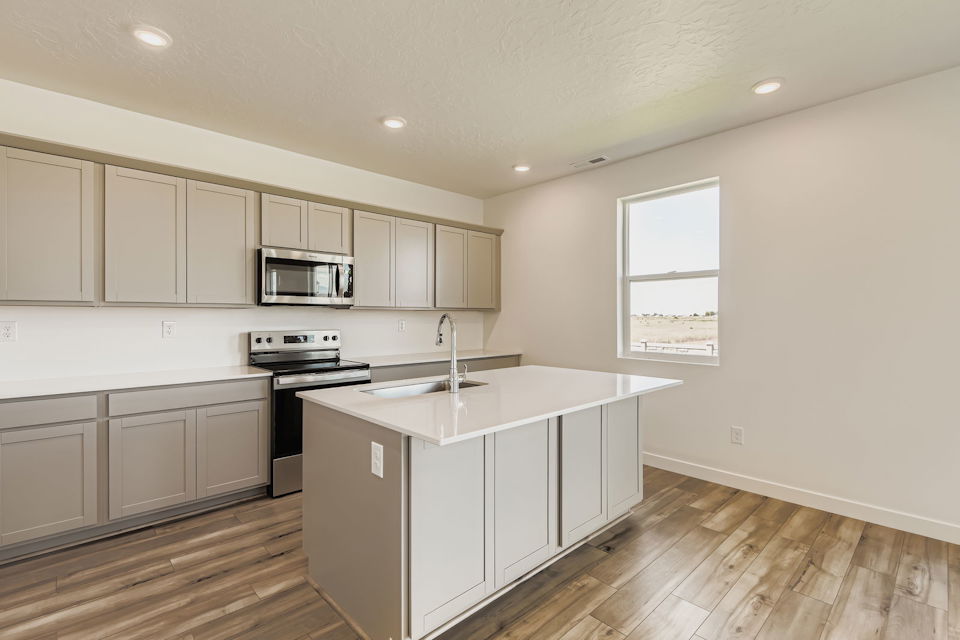 A kitchen with white cabinets.