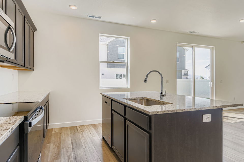 A kitchen with a sink and a window.