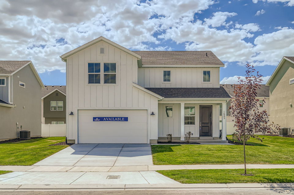 A building with a tree in front.