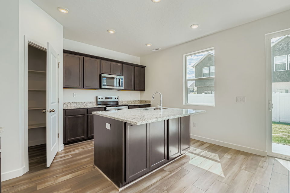 A kitchen with black cabinets.
