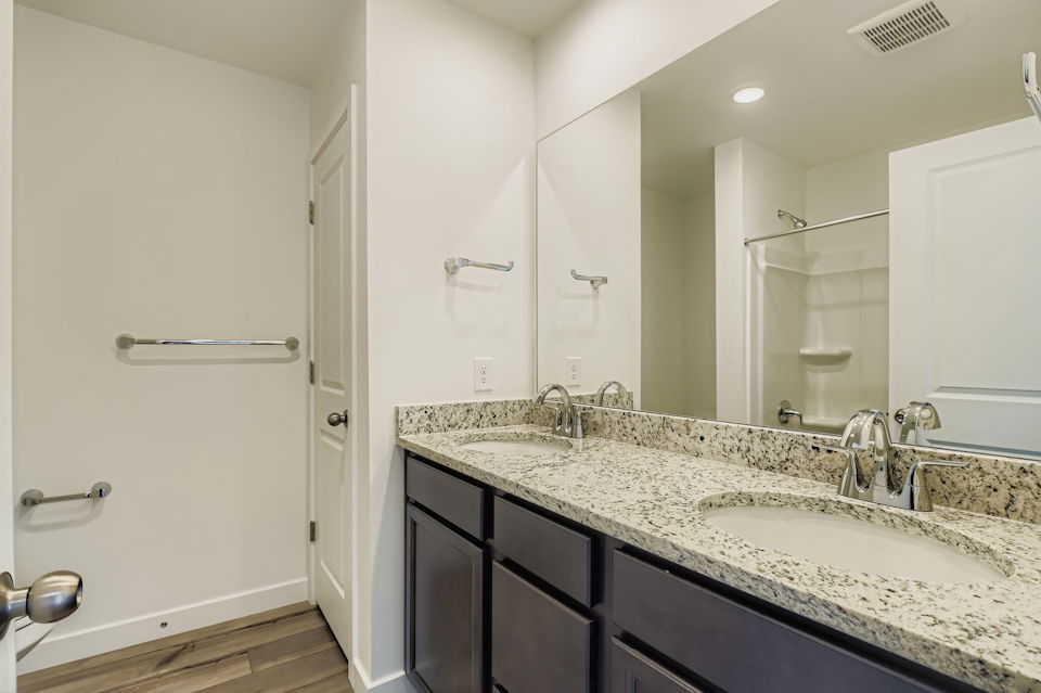 A bathroom with a large mirror.