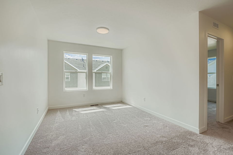 A room with a window and a carpet.