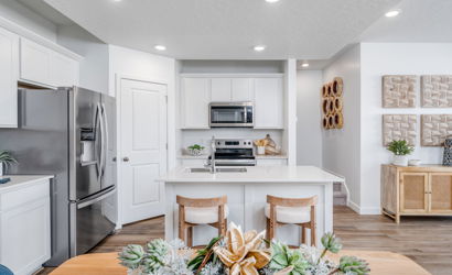 A kitchen with white cabinets.