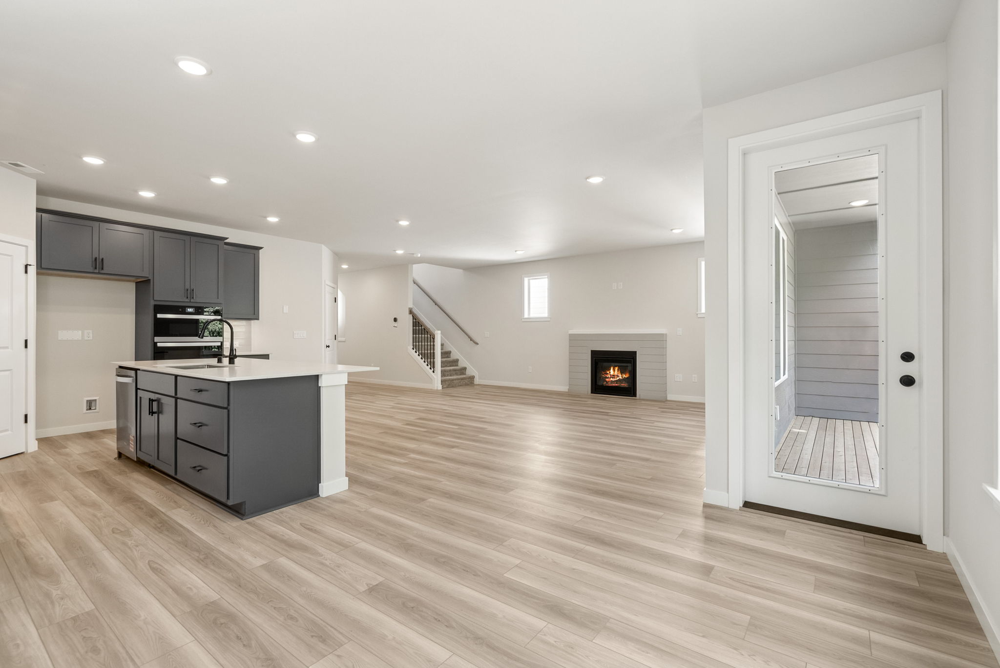 A large kitchen with black cabinets.