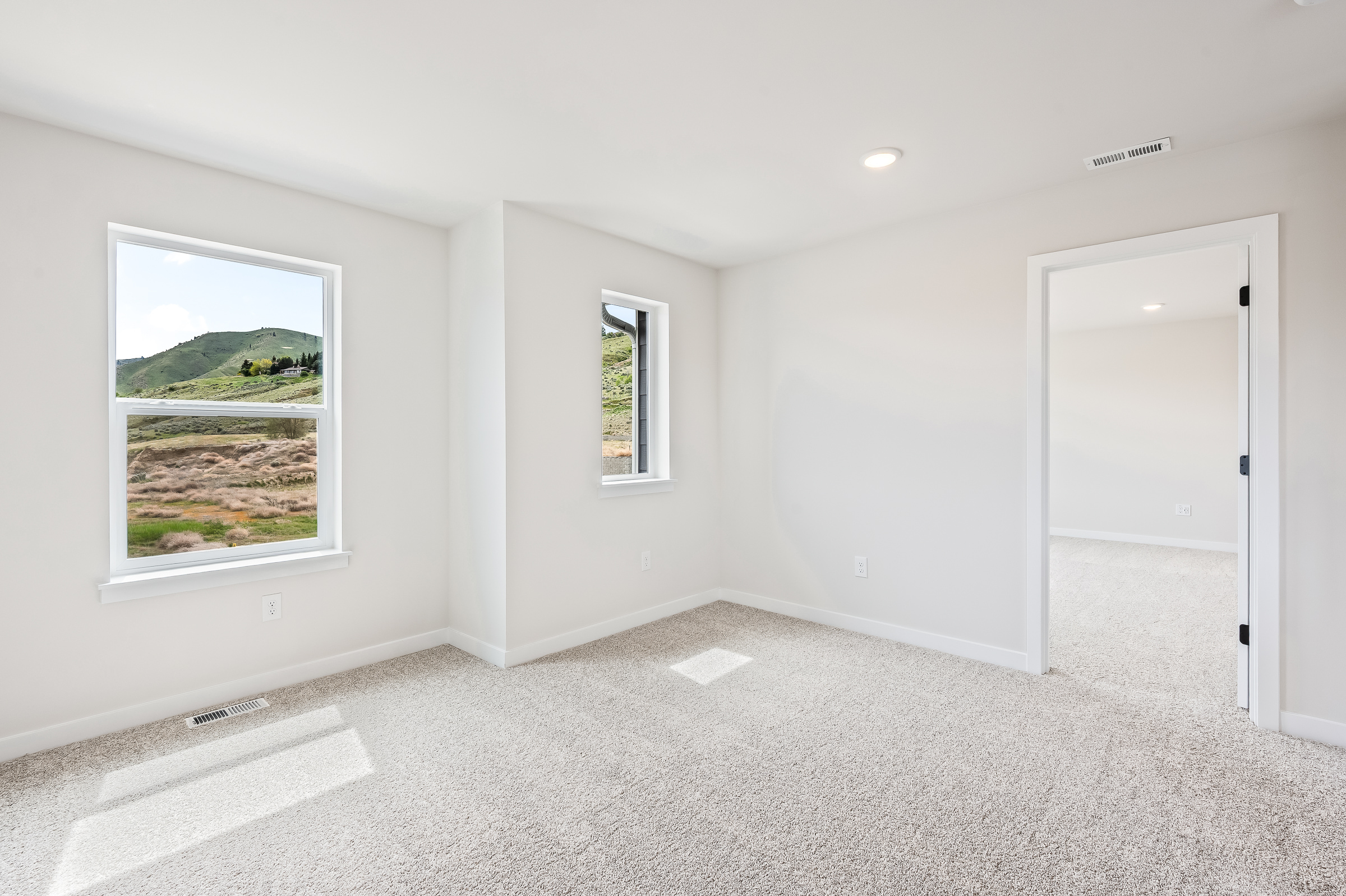 A room with a window and a door.