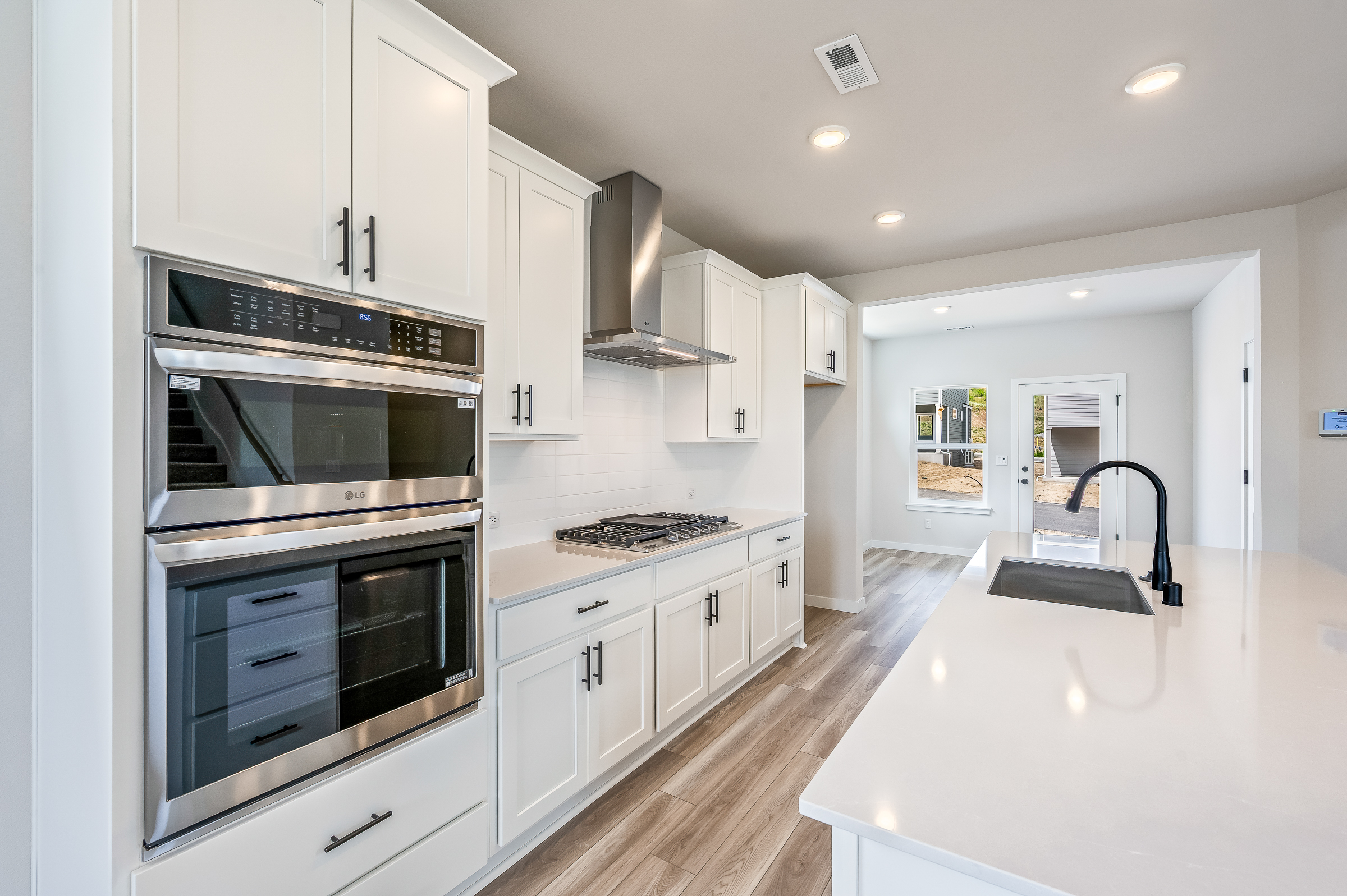 A kitchen with white cabinets.