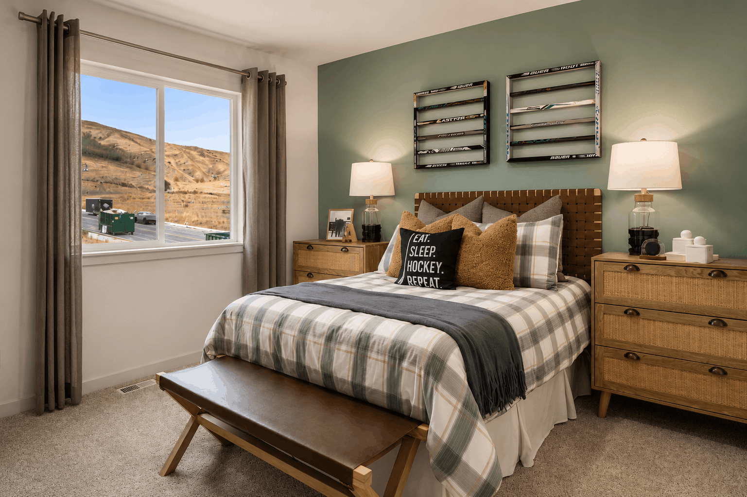 A bedroom with a bed and a bench.