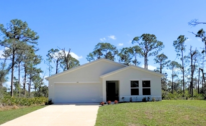 A house with a driveway and grass.