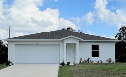 A white house with a garage.