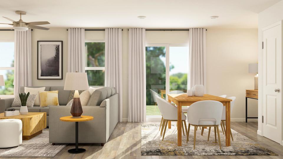 A living room with a table and chairs.