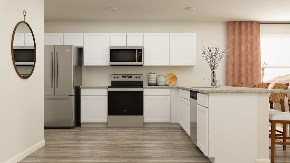 A kitchen with white cabinets.