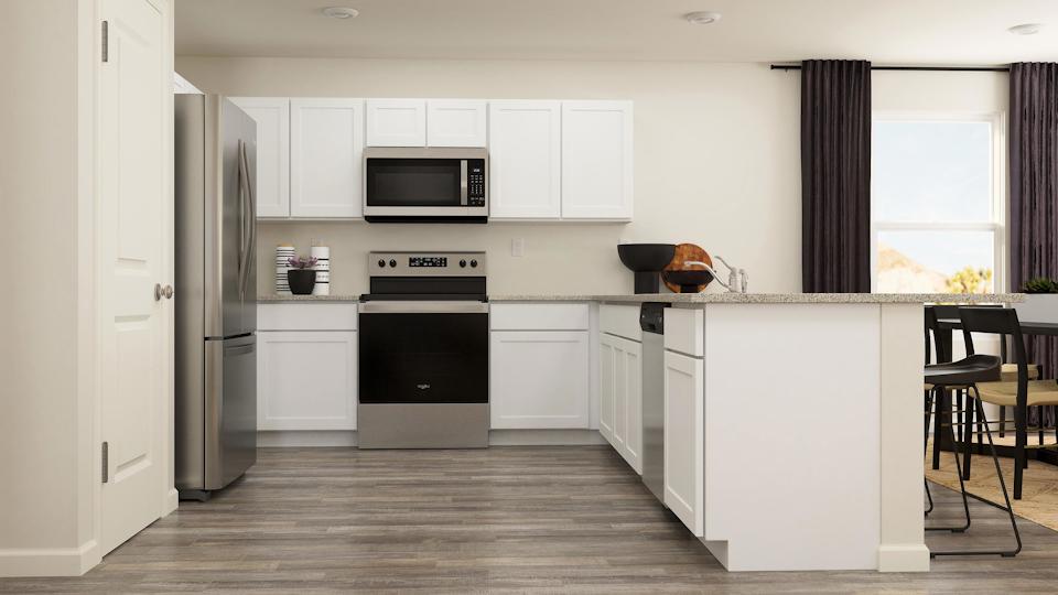A kitchen with white cabinets.