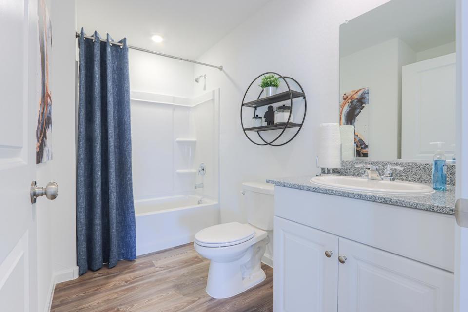 A bathroom with a tub toilet and sink.