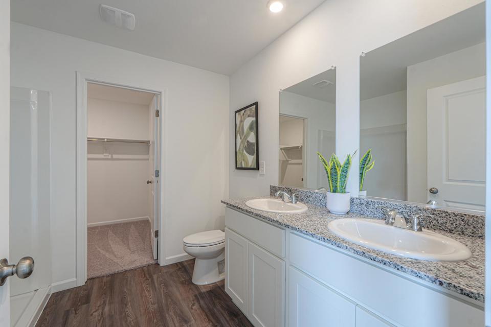 A bathroom with a sink toilet and a shower.