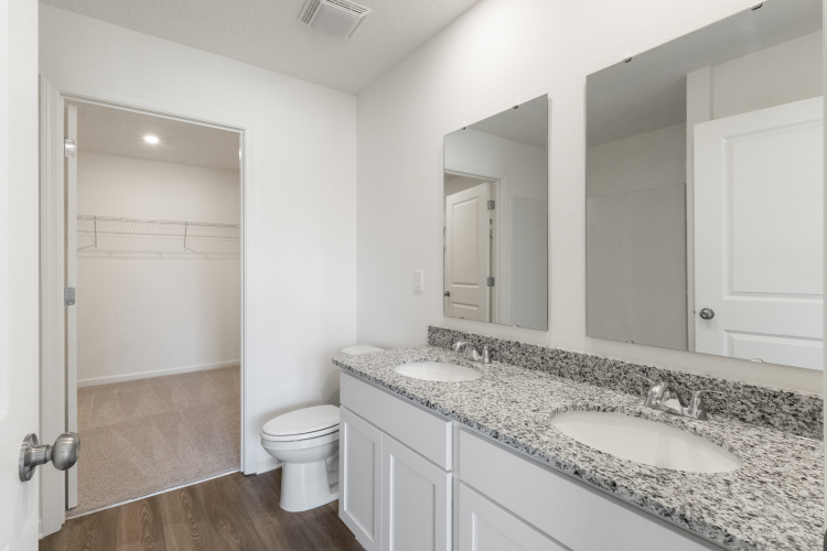A bathroom with a marble countertop.