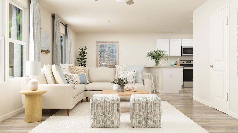 A living room with white furniture.