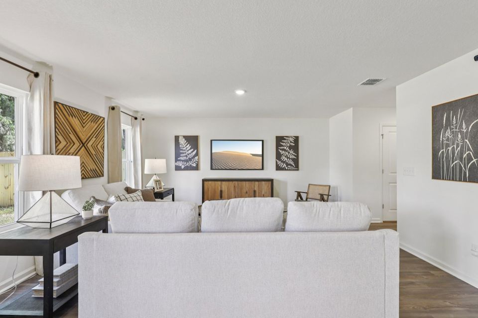 A large white living room with a large white couch.