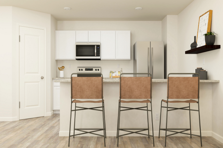 A kitchen with white cabinets.