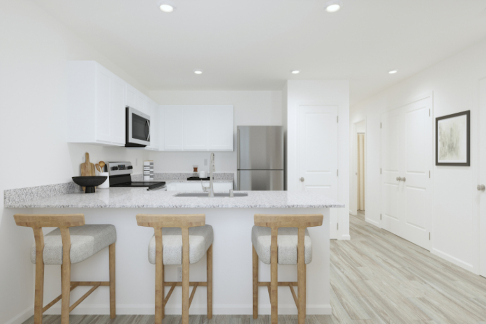 A kitchen with white cabinets.