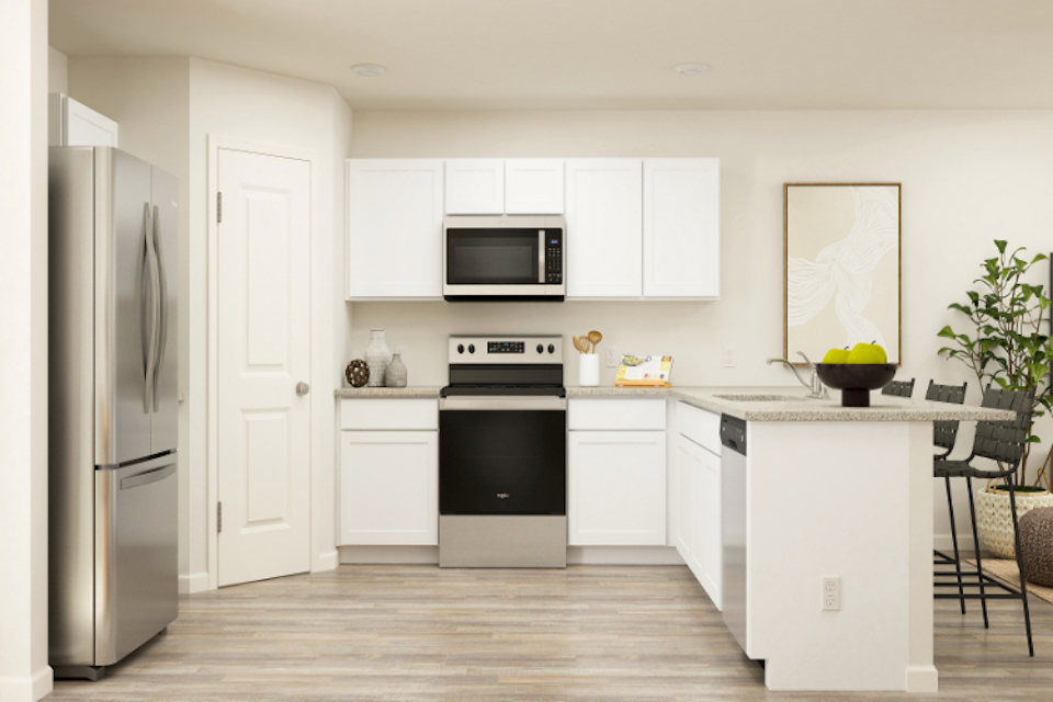 A kitchen with white cabinets.