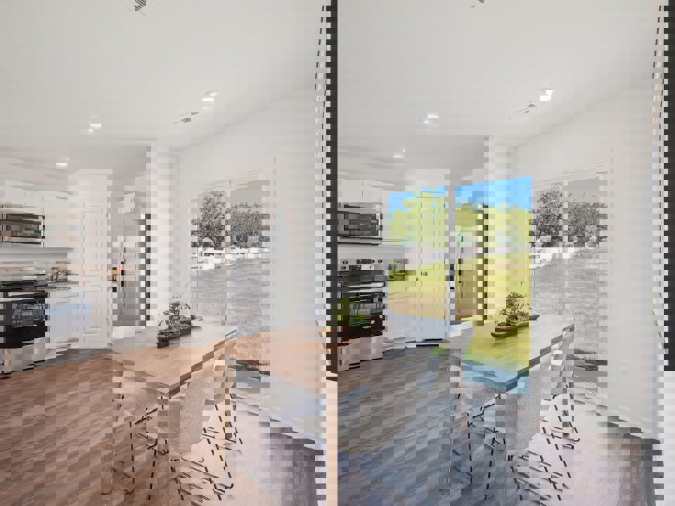 A kitchen with a table and chairs.