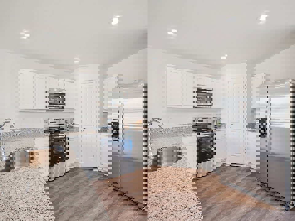 A kitchen with white cabinets.