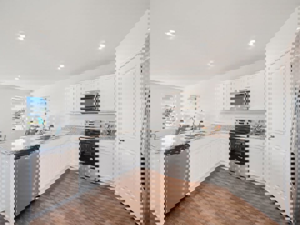 A kitchen with white cabinets.