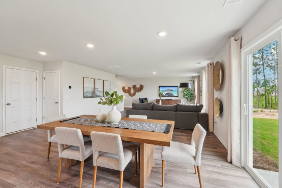 A living room with a table and chairs.