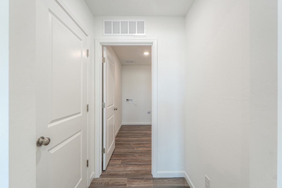 A hallway with white doors.