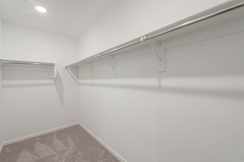 A white wall with a metal railing.