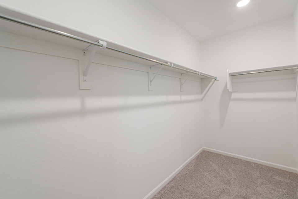 A white wall with a metal bar.