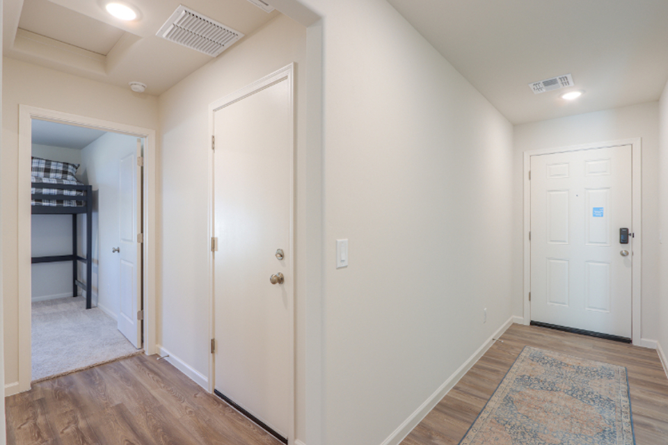 A hallway with white doors.