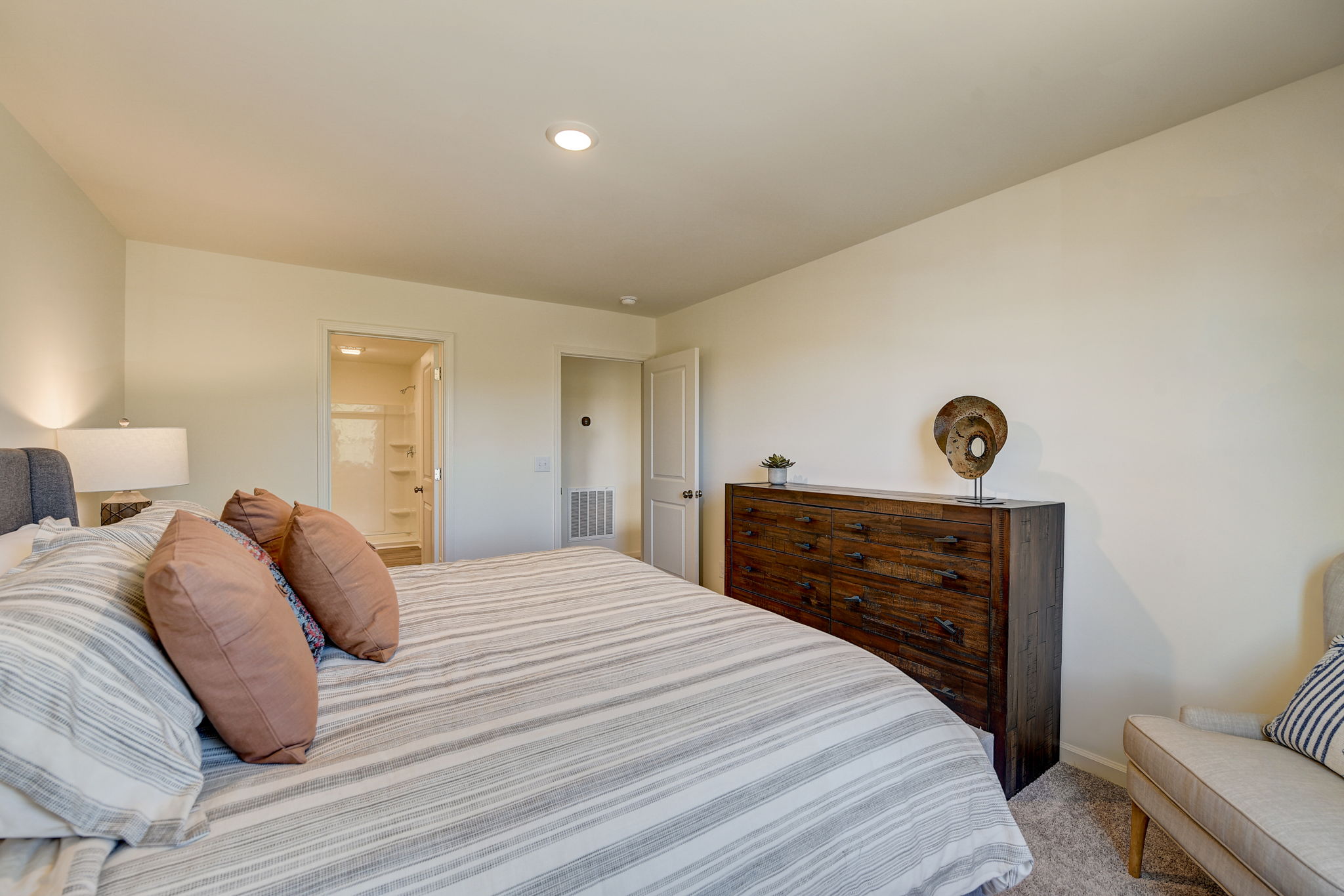 A bedroom with a bed and a dresser.