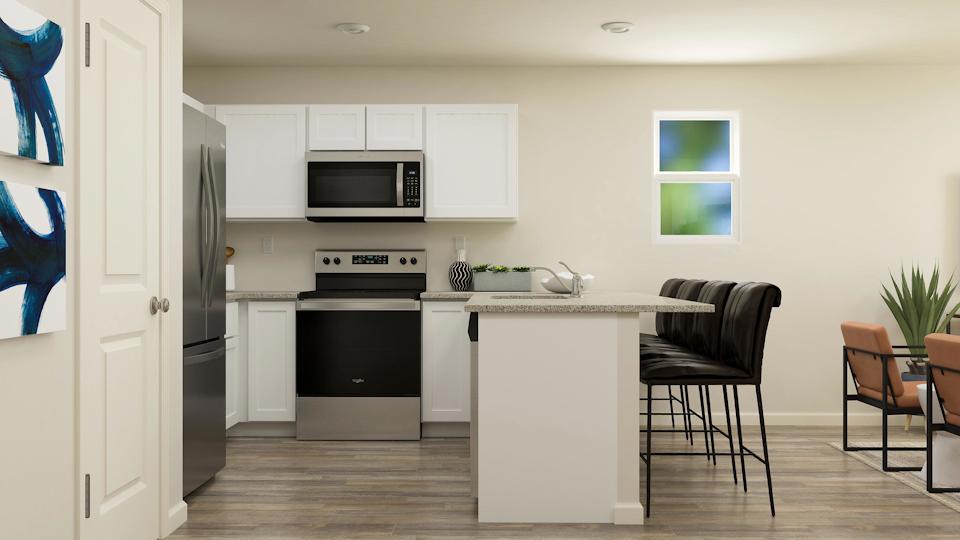 A kitchen with white cabinets.