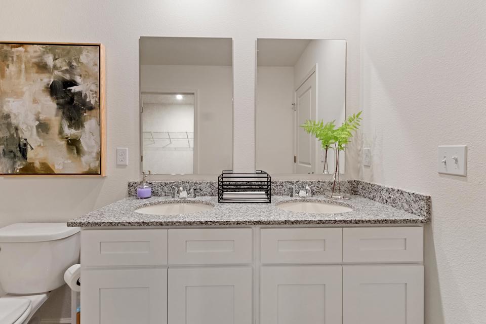 A bathroom with a marble countertop.