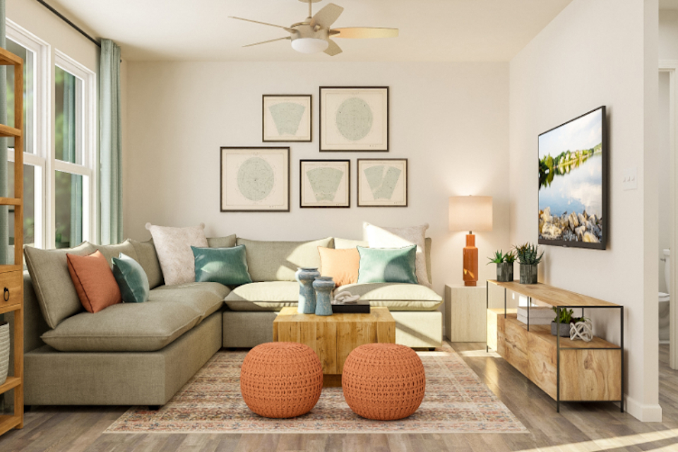 A living room with a couch and a fan.