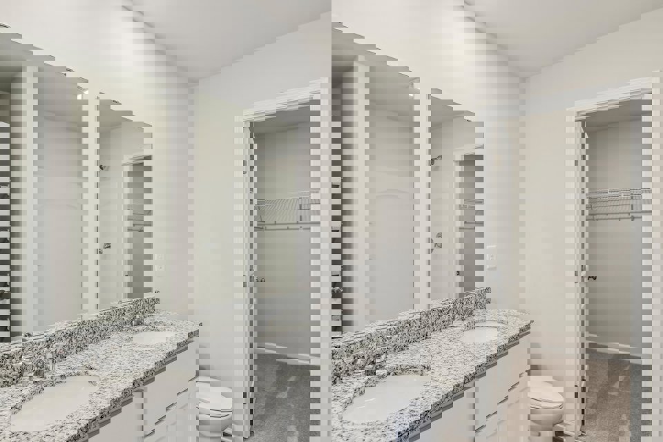 A bathroom with a marble countertop.