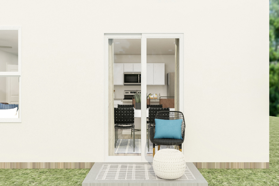 A room with a table chairs and a glass door.