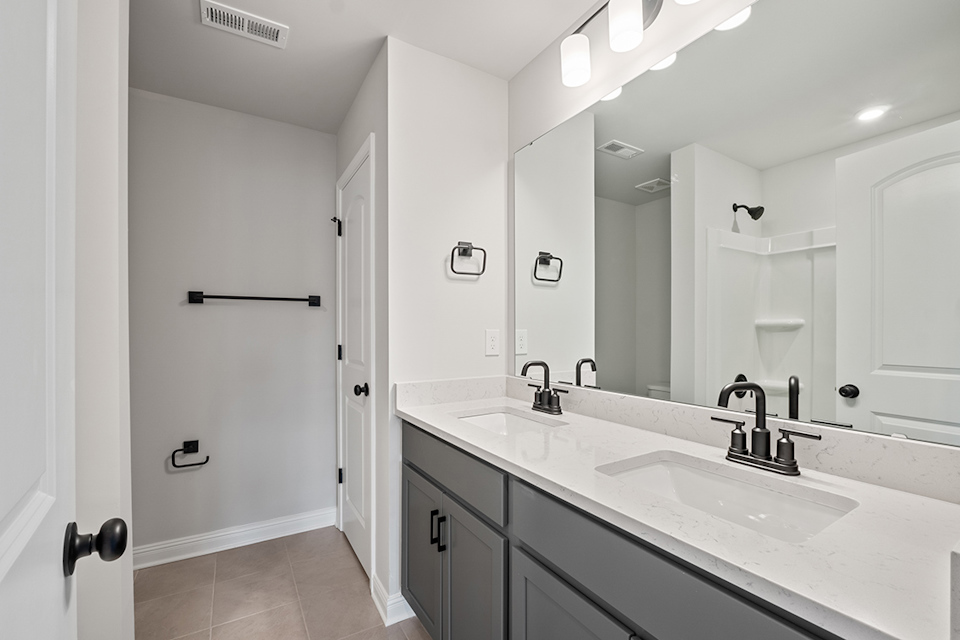 A bathroom with a large mirror.